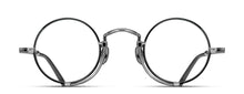 Load image into Gallery viewer, Optical glasses frames are pictured, displaying a frontal view. The glasses feature a round lens shape outlined in black and a M + N engraving along the rim wire. The glasses are stylized with a Pince-nez inspiration.