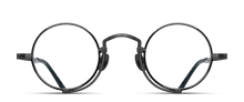 Load image into Gallery viewer, Optical glasses frames are pictured, displaying a frontal view. The glasses feature a round lens shape outlined in black and a M + N engraving along the rim wire.