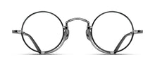Load image into Gallery viewer, Optical glasses frames are pictured, displaying a frontal view. The glasses feature a round lens shape outlined in black and a M + N engraving along the rim wire. The glasses are stylized with a Pince-nez inspiration.
