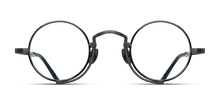 Load image into Gallery viewer, Optical glasses frames are pictured, displaying a frontal view. The glasses feature a round lens shape outlined in black and a M + N engraving along the rim wire.
