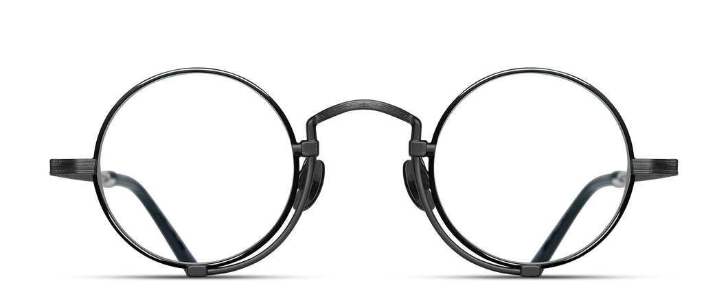 Optical glasses frames are pictured, displaying a frontal view. The glasses feature a round lens shape outlined in black and a M + N engraving along the rim wire.