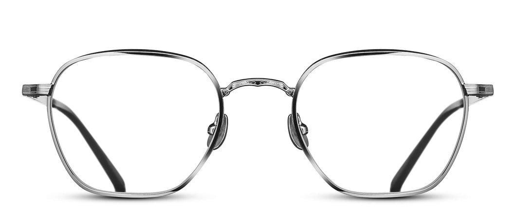 A silver-colored titanium optical glasses frame is pictured. The frame features a hexagonal shaped lens. 