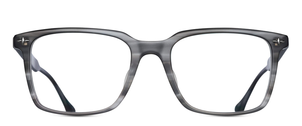 An acetate, square-shaped glasses frame is pictured. The frame is a matte gray color and features a silver filigree rivets in each of the frame's corners. 